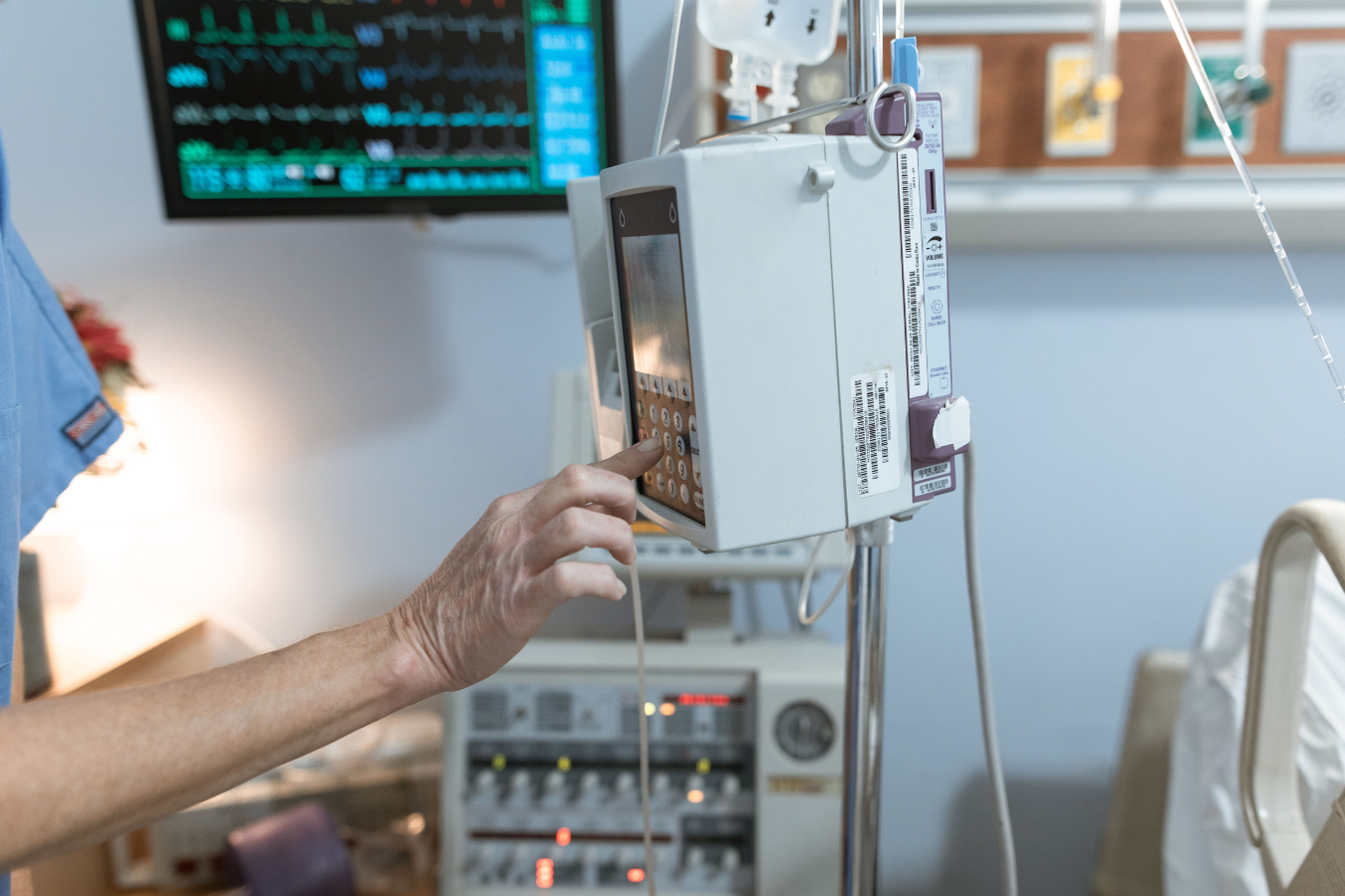 A clinician using a hardware device to check a patients' readings.